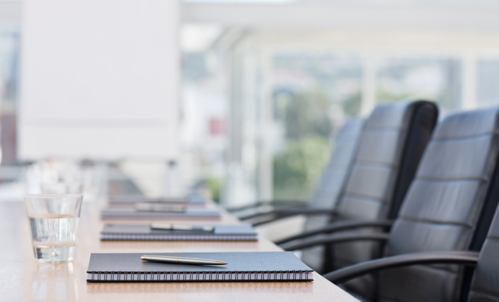 Commercial litigation attorney in Arizona resolving business disputes with an empty conference table and legal documents