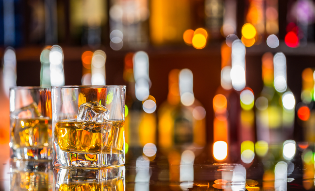 Dram shop liability attorney in Arizona handling alcohol-related injury claims shown with a glass of alcohol on a bar counter